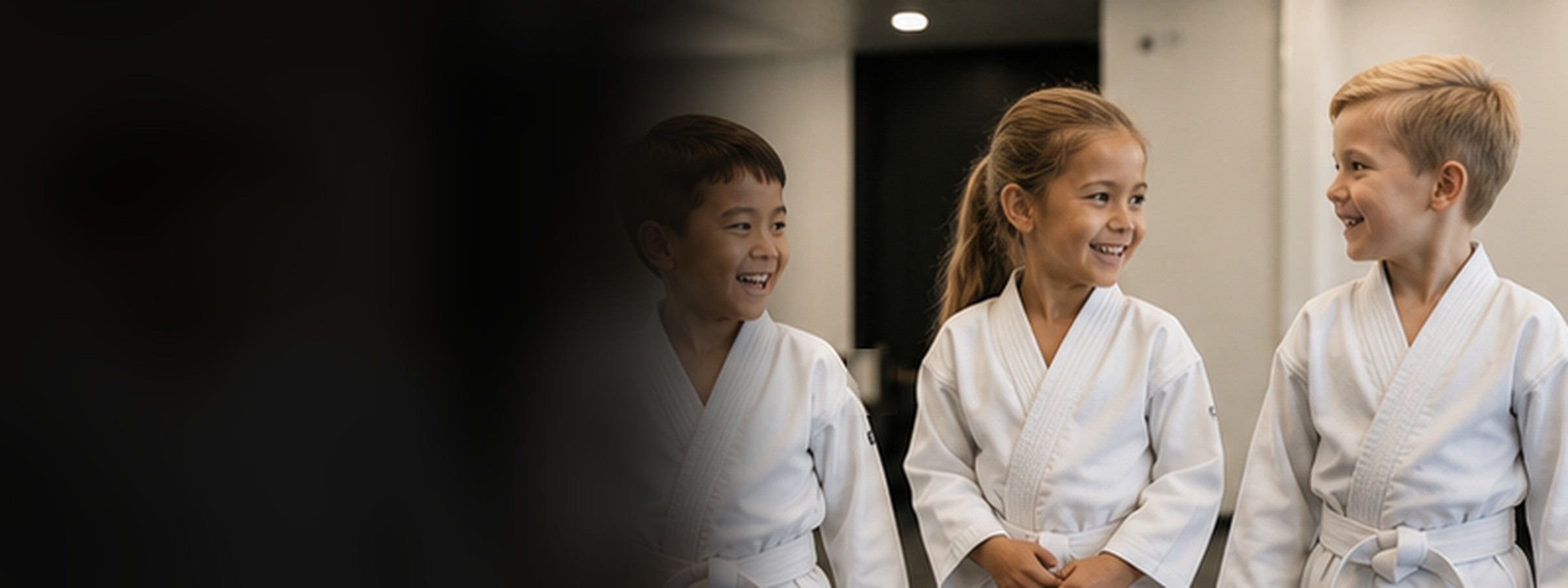 Kids martial arts students building confidence together in a bright dojo